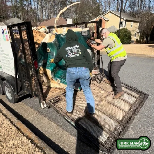 Hot tub demolition in Kennesaw Georgia with junk man cutting apart and removing an old spa from backyard property