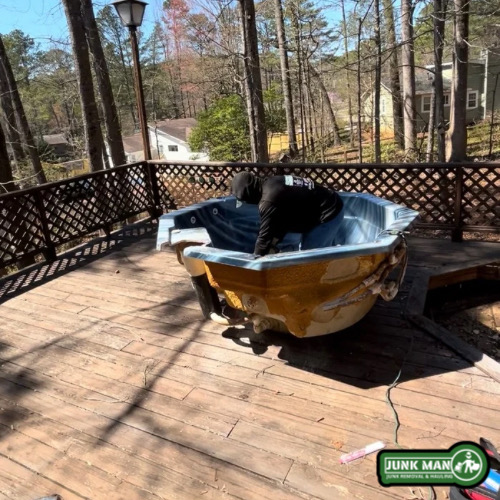 Professional Jacuzzi removal in Kennesaw GA with junk Man dismantling and hauling away backyard hot tub sections safely