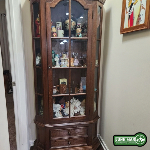 Household furniture donation pickup in Kennesaw GA featuring glass curio cabinet donation removal